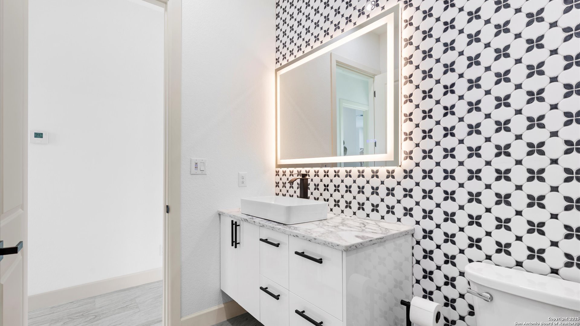 22327 Scenic Loop Road San Antonio, TX 78255 - Photo 48 of 59 a bathroom with a sink and a mirror