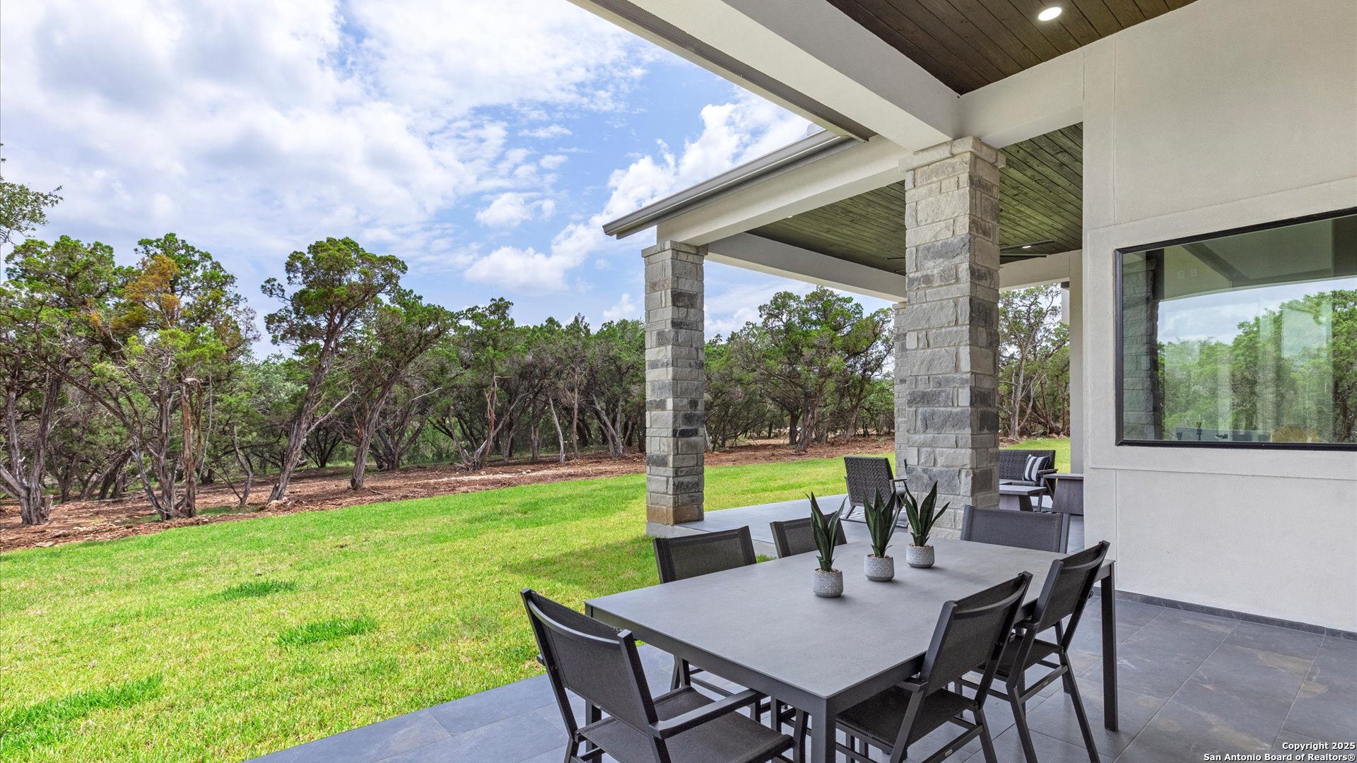 22327 Scenic Loop Road San Antonio, TX 78255 - Photo 55 of 59 a view of an outdoor dining space with furniture and garden