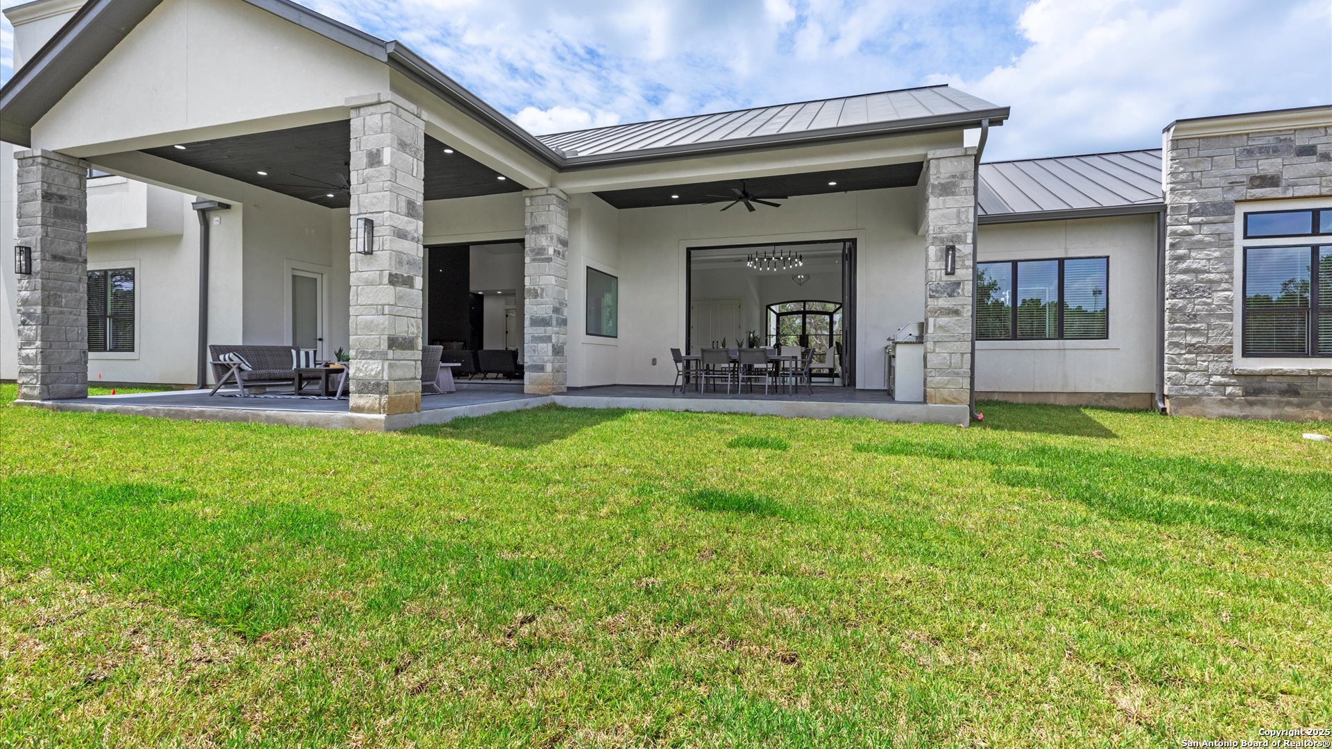22327 Scenic Loop Road San Antonio, TX 78255 - Photo 56 of 59 a view of a house with a yard and sitting area