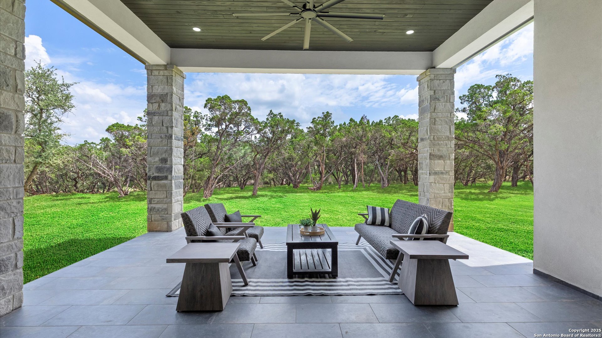 22327 Scenic Loop Road San Antonio, TX 78255 - Photo 57 of 59 a view of a patio with couches chairs and a yard