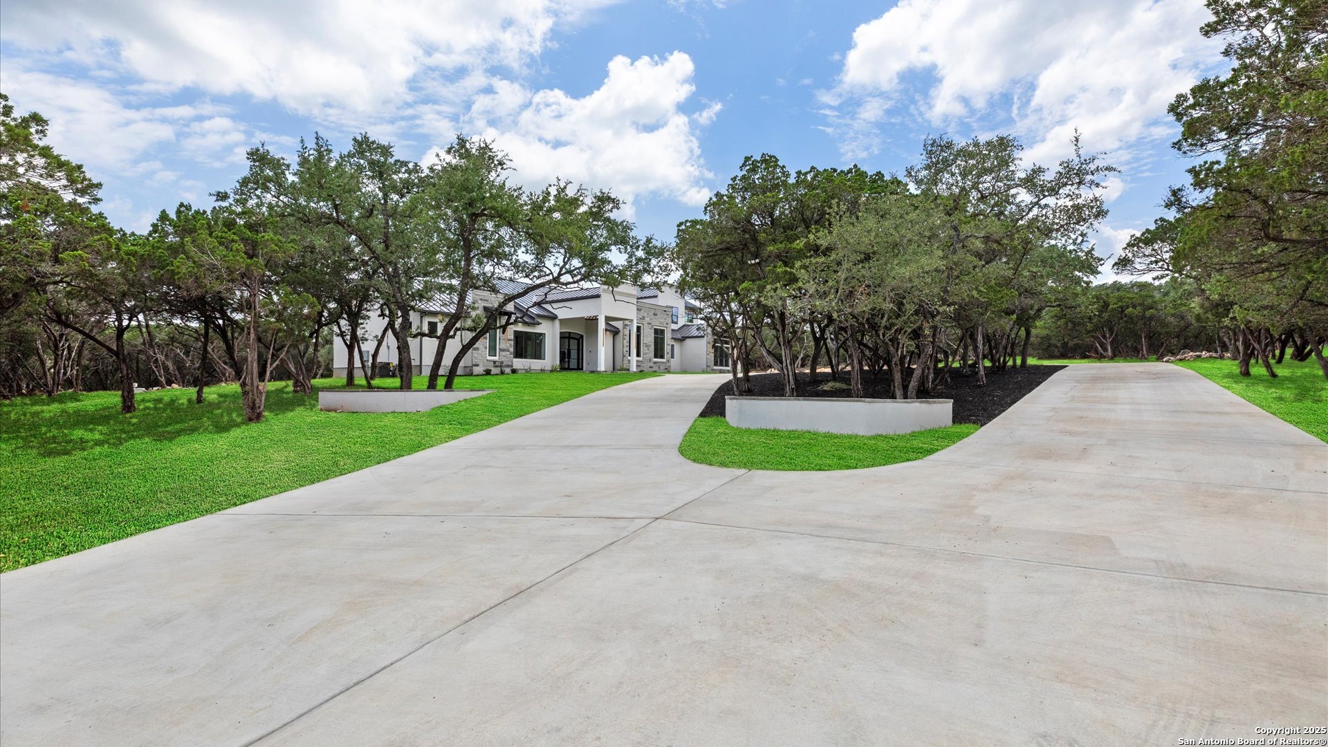 22327 Scenic Loop Road San Antonio, TX 78255 - Photo 7 of 59 a view of a house with a yard