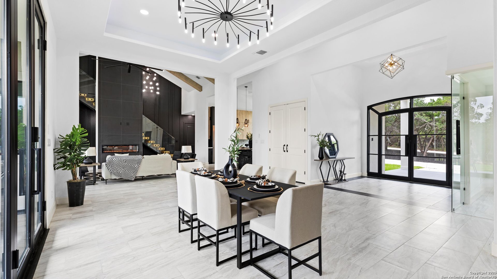22327 Scenic Loop Road San Antonio, TX 78255 - Photo 9 of 59 a dining room with furniture a chandelier and wooden floor