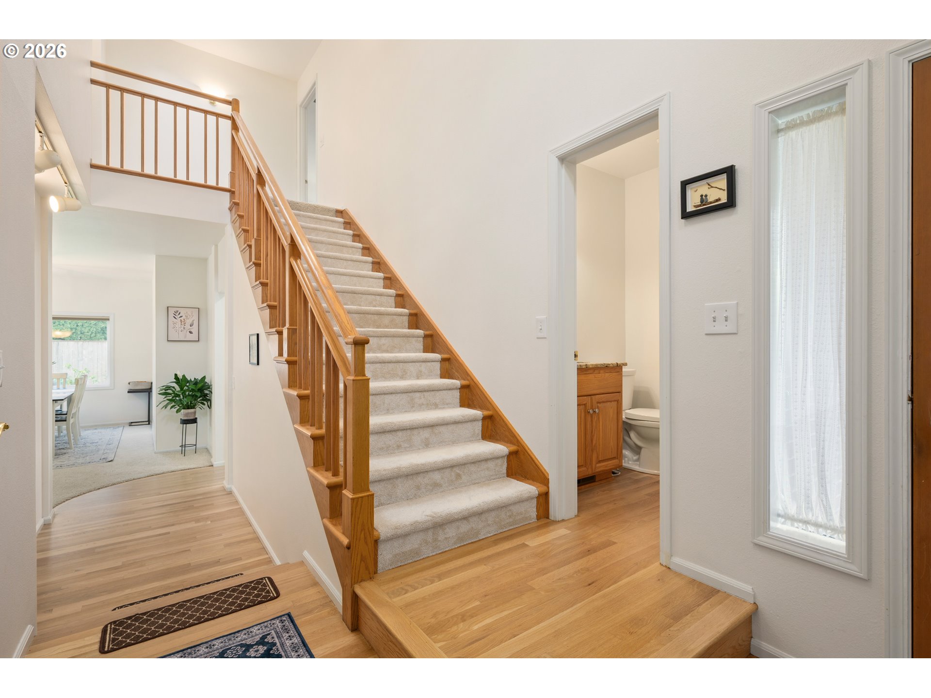2436 Greiner Street Eugene, OR 97405 - Photo 19 of 45 a view of a hallway with wooden floor and staircase