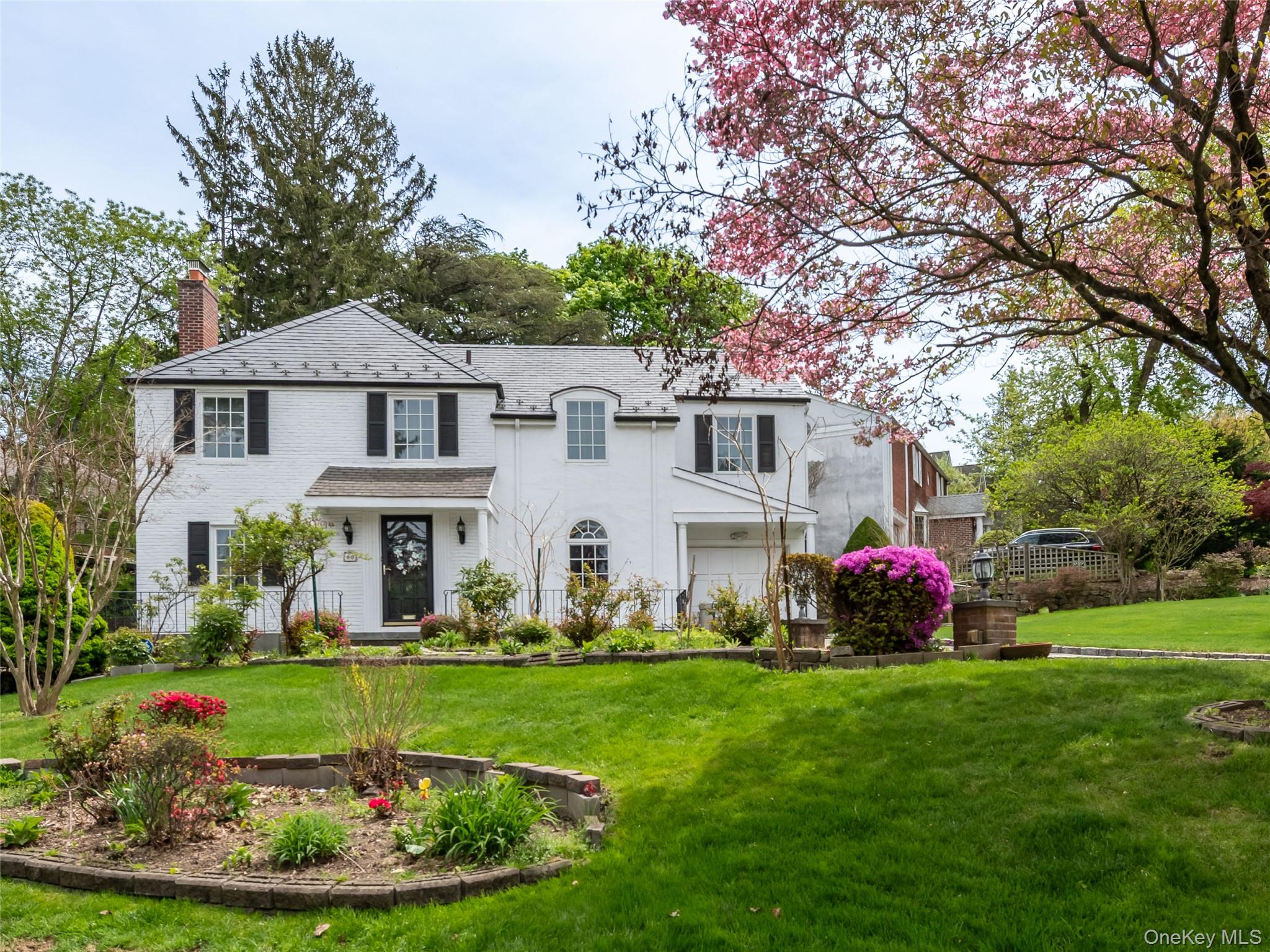 60 Mill Spring Road Manhasset, NY 11030 - Photo 18 of 18 a front view of house with yard and green space