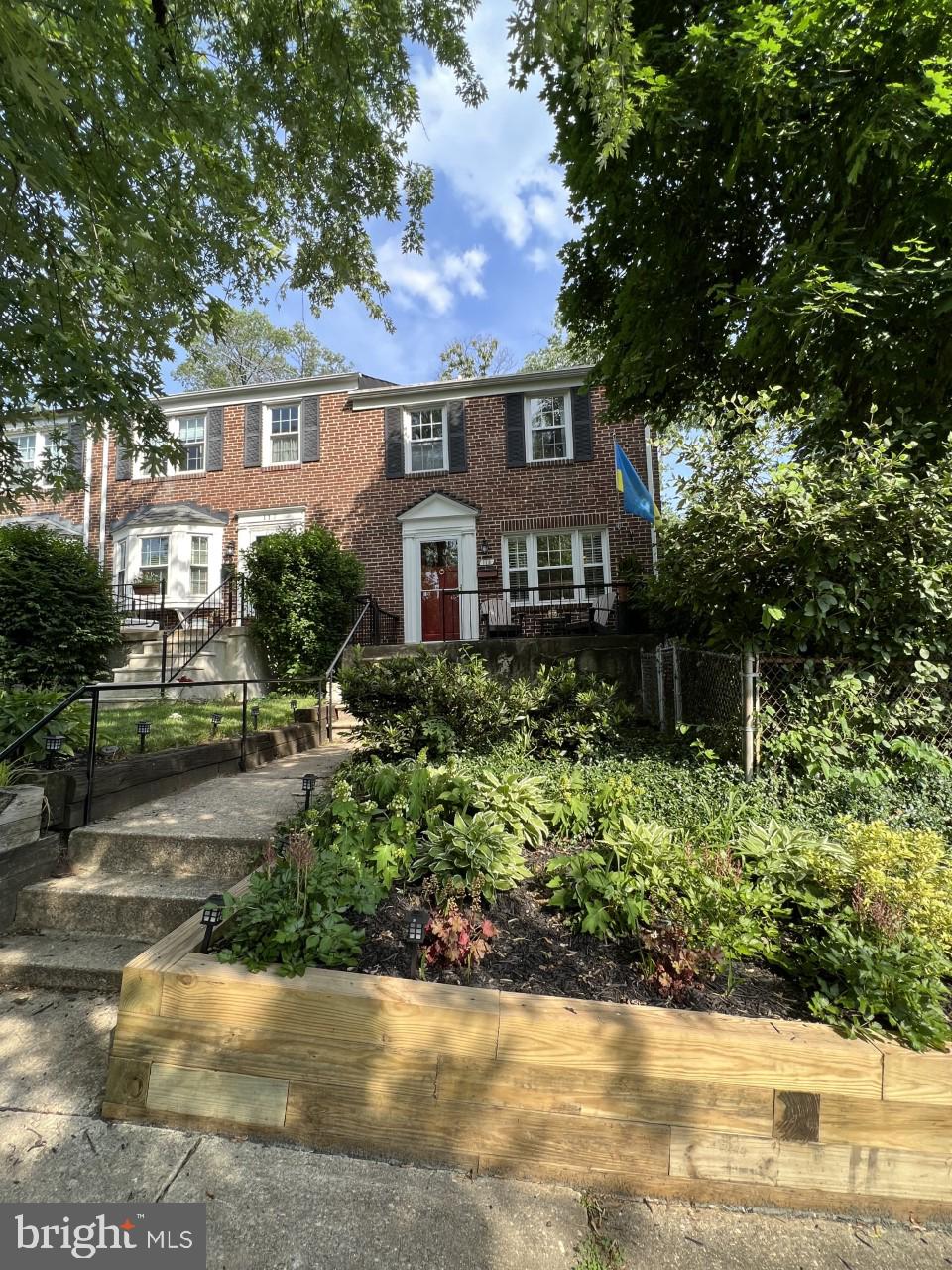 115 Brandon Road Baltimore, MD 21212 - Photo 1 of 39 a front view of a house with a yard and a garden