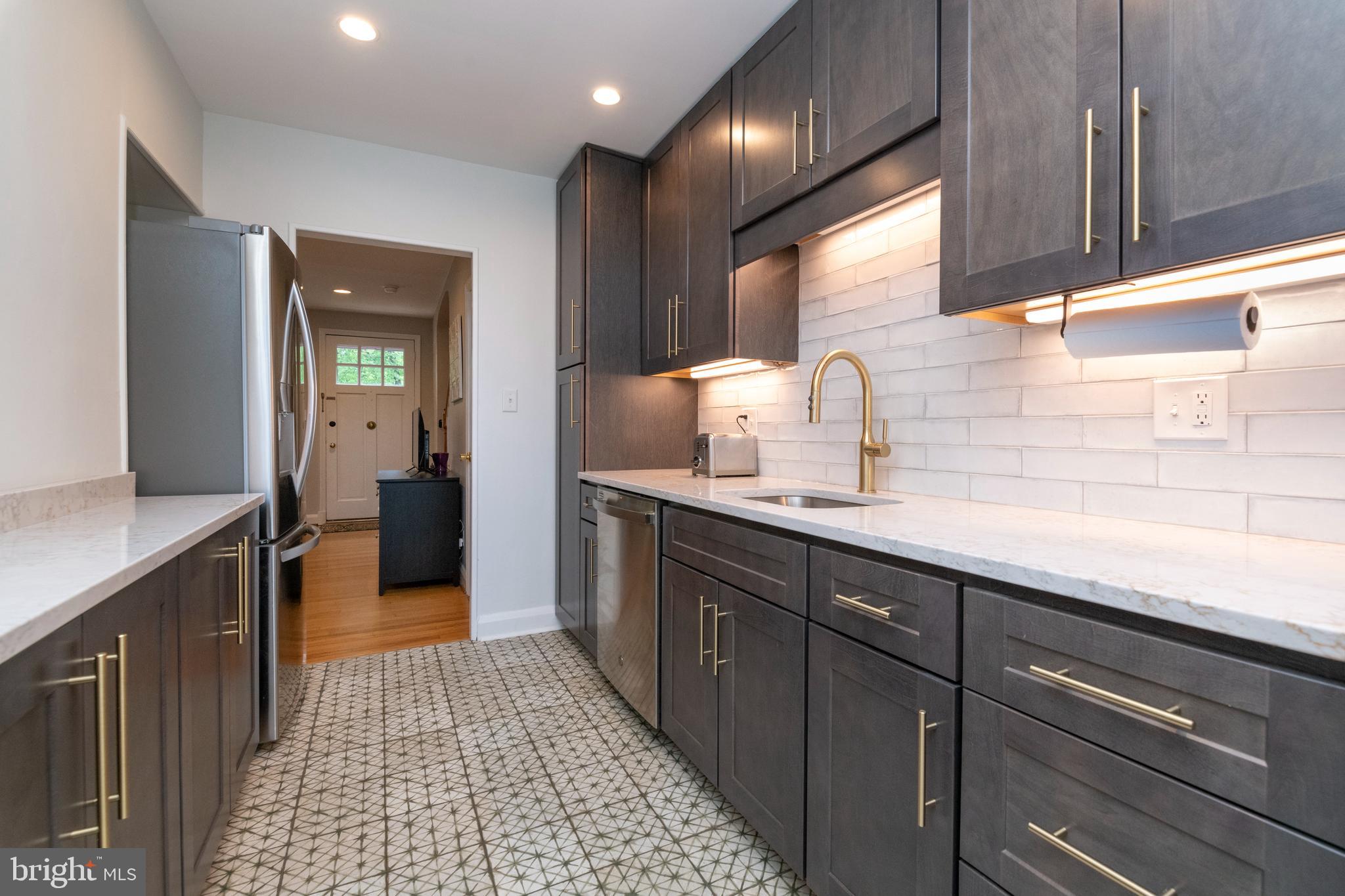 115 Brandon Road Baltimore, MD 21212 - Photo 11 of 39 a kitchen with a sink and cabinets