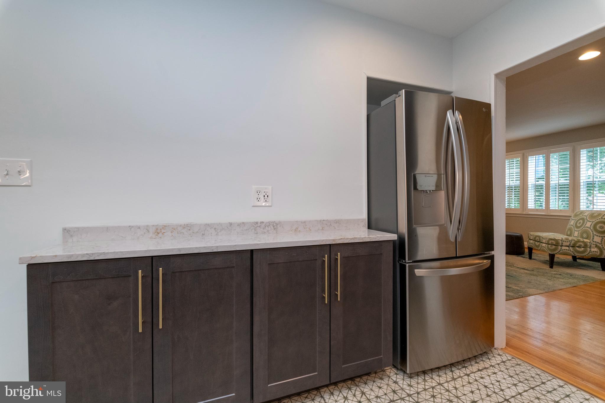 115 Brandon Road Baltimore, MD 21212 - Photo 13 of 39 a kitchen with metallic refrigerator freezer and a dishwasher