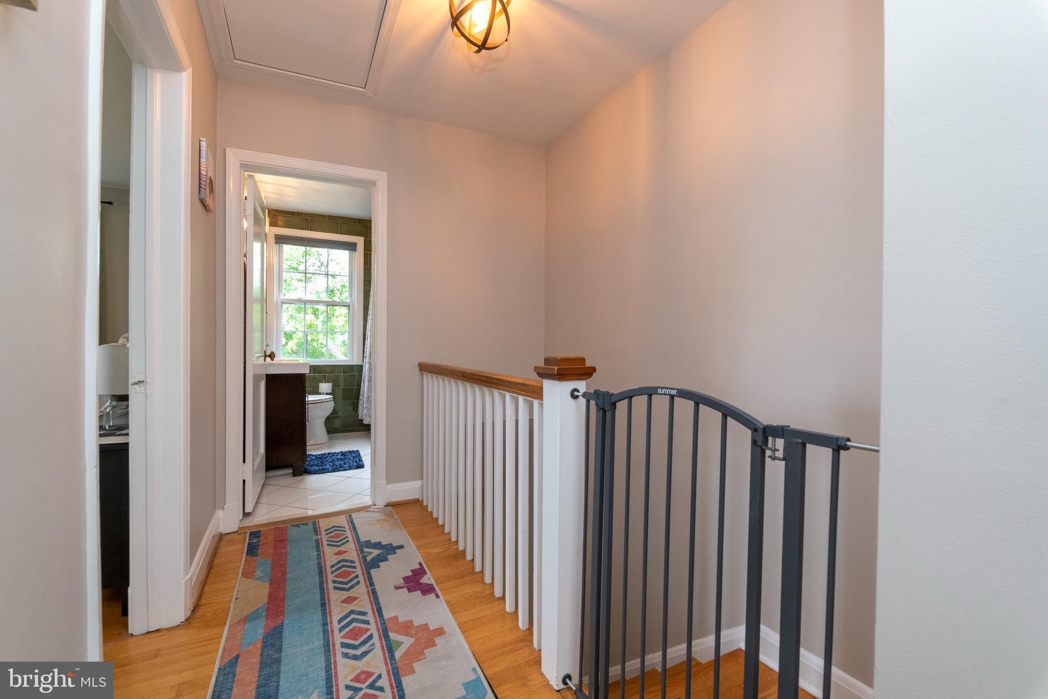 115 Brandon Road Baltimore, MD 21212 - Photo 14 of 39 a view of a hallway with wooden floor and a bathroom