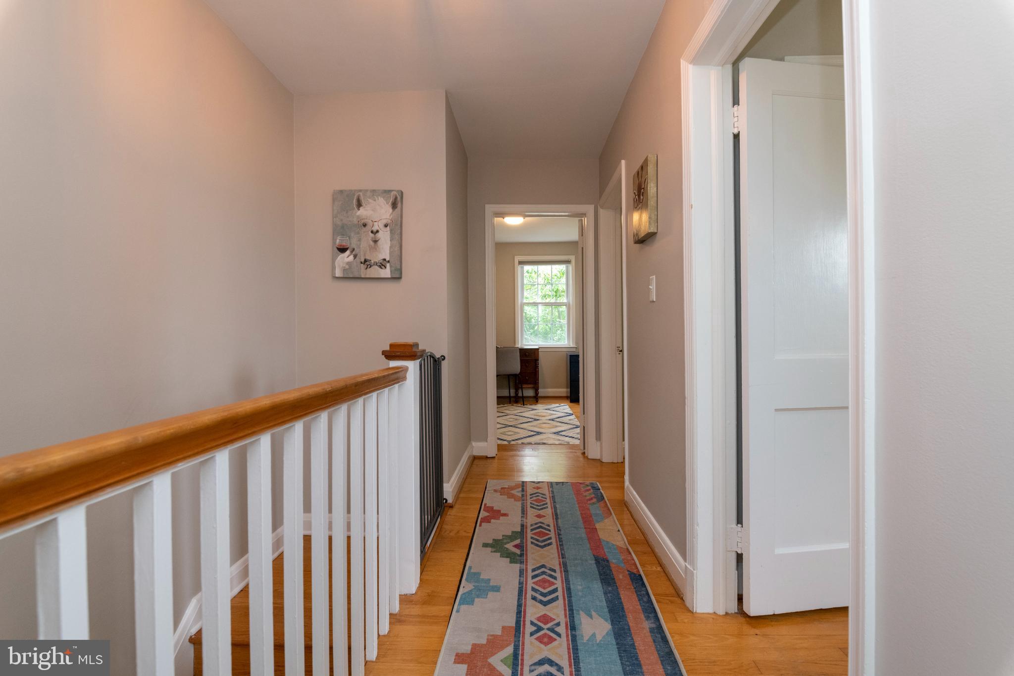 115 Brandon Road Baltimore, MD 21212 - Photo 21 of 39 a view of a hallway with wooden floor and a bathroom