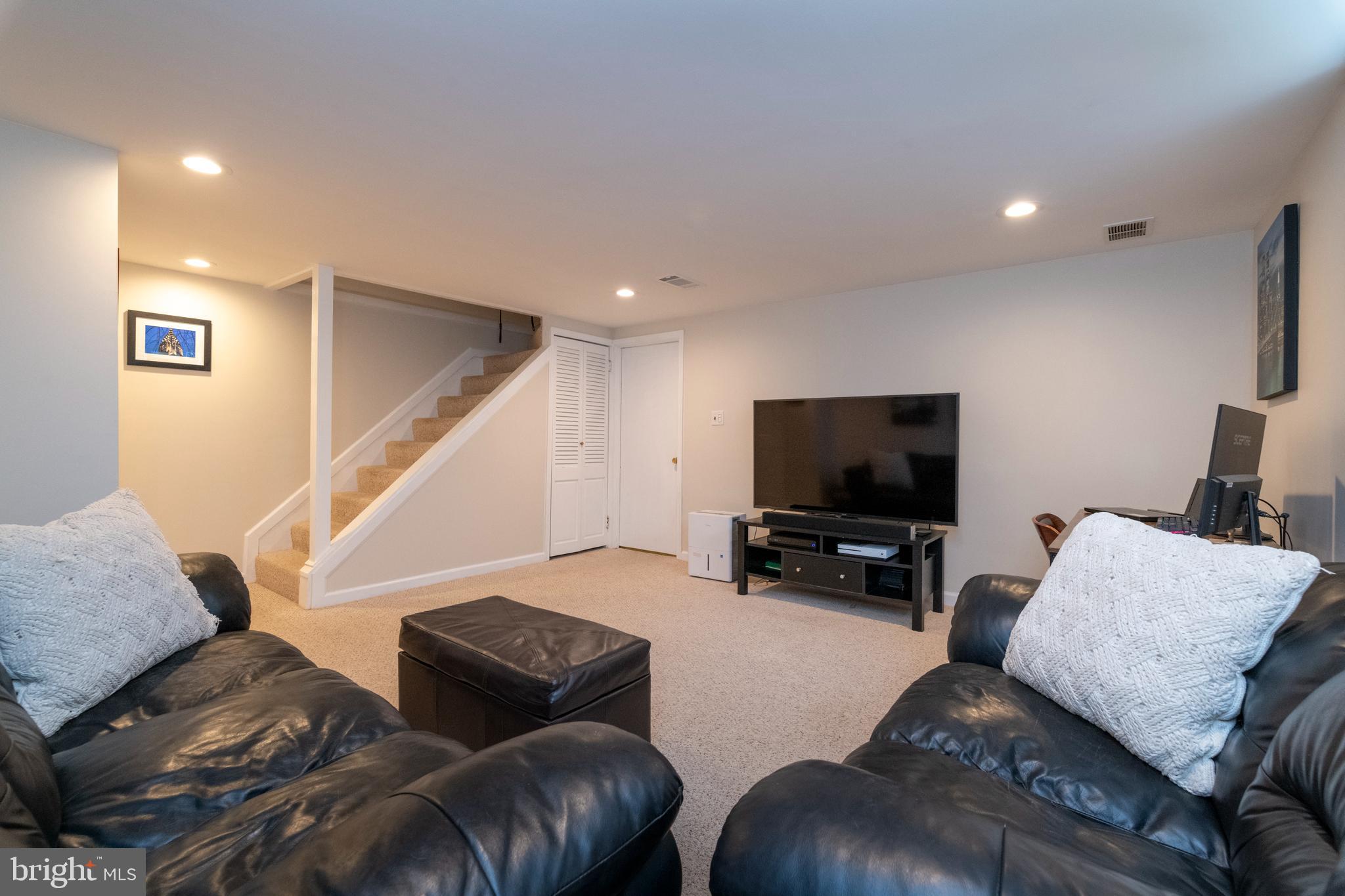 115 Brandon Road Baltimore, MD 21212 - Photo 27 of 39 a living room with furniture and a flat screen tv