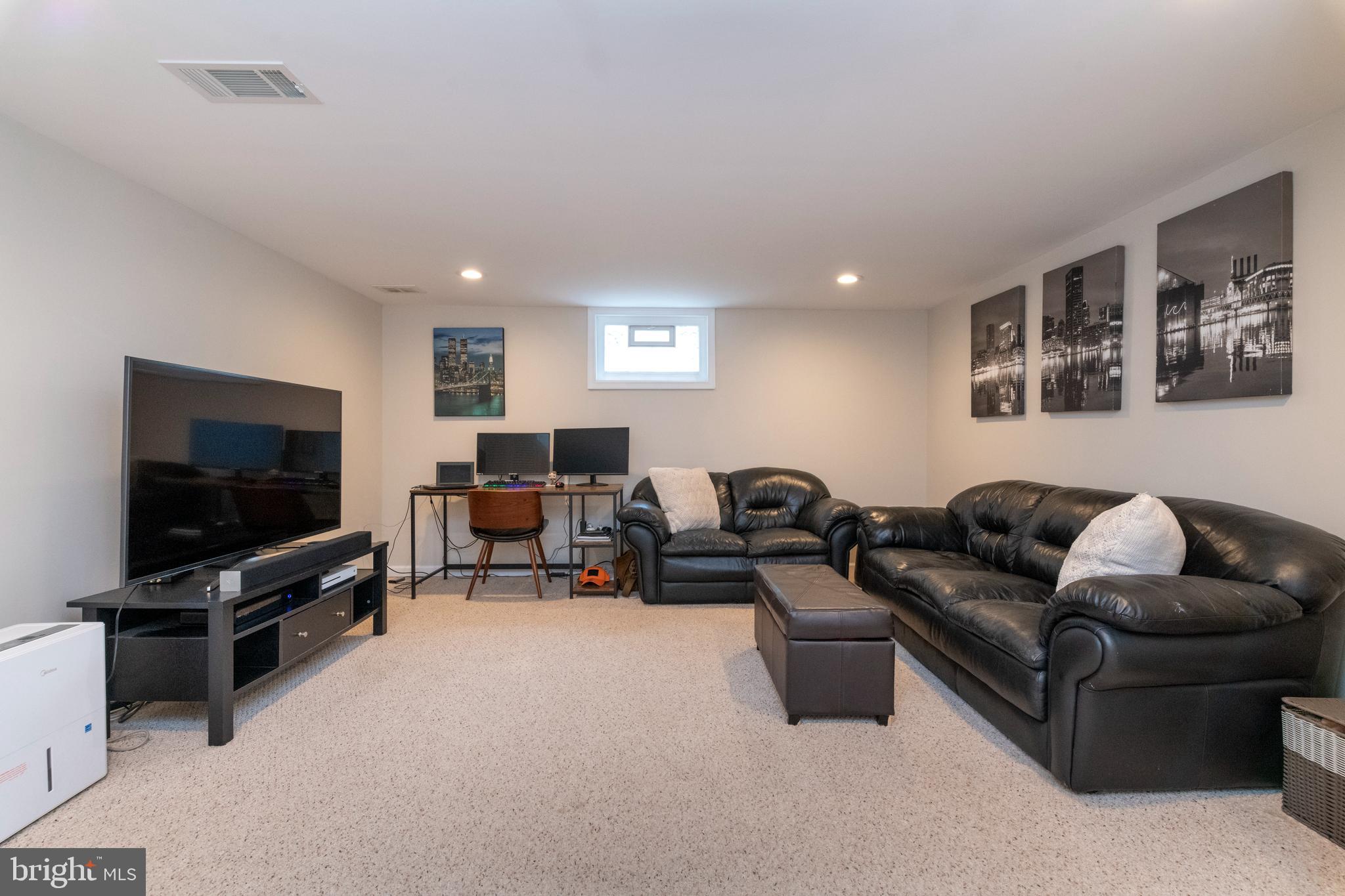 115 Brandon Road Baltimore, MD 21212 - Photo 29 of 39 a living room with furniture and a flat screen tv