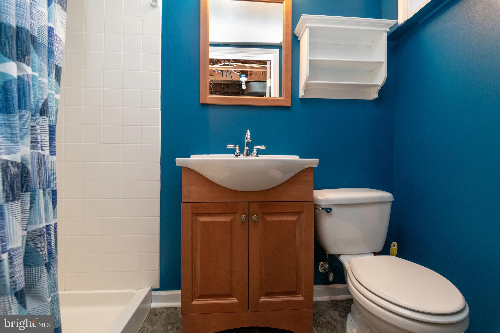115 Brandon Road Baltimore, MD 21212 - Photo 31 of 39 a bathroom with a toilet a sink and mirror