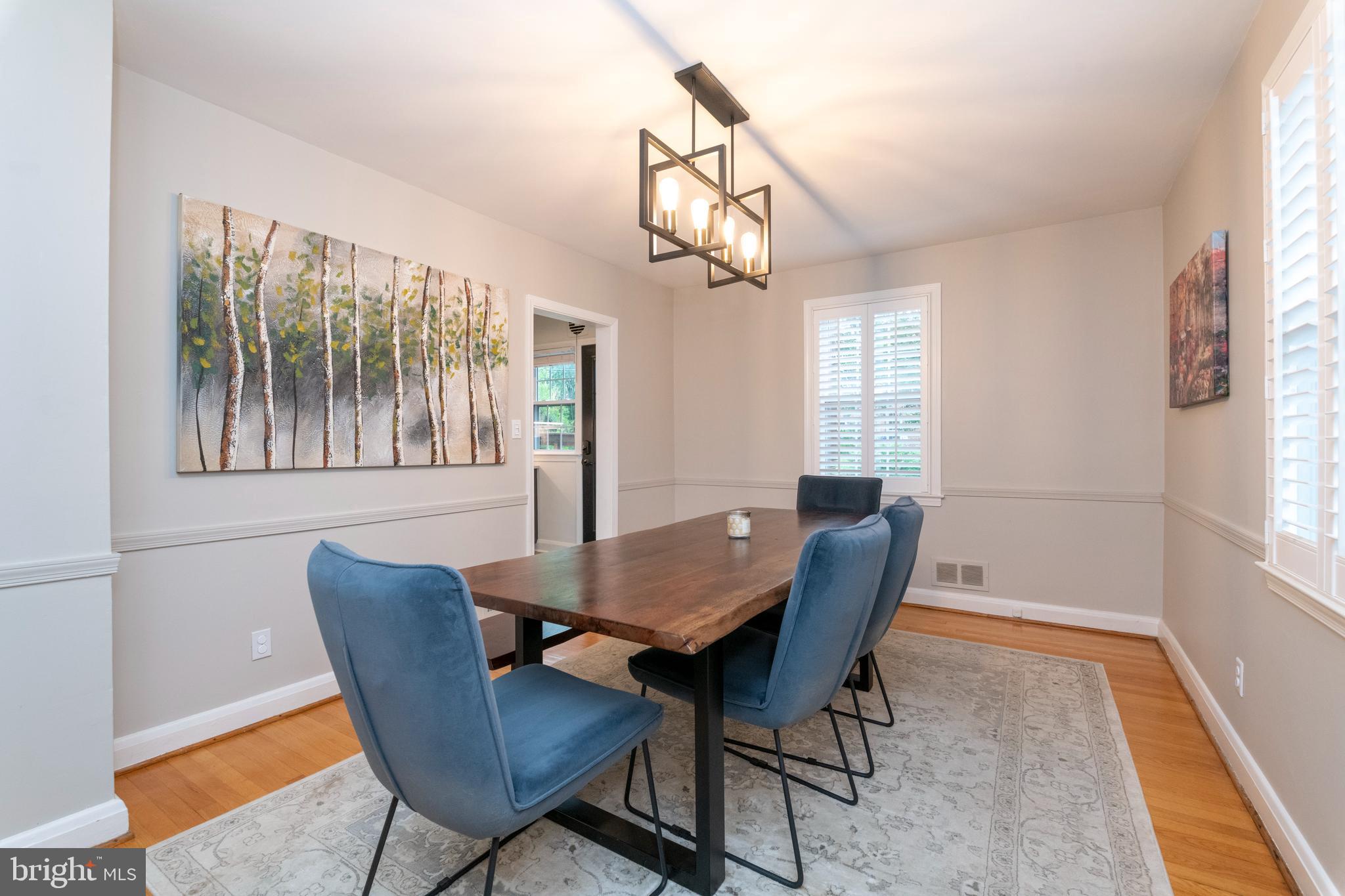 115 Brandon Road Baltimore, MD 21212 - Photo 7 of 39 a view of a dining room with furniture wooden floor and a chandelier