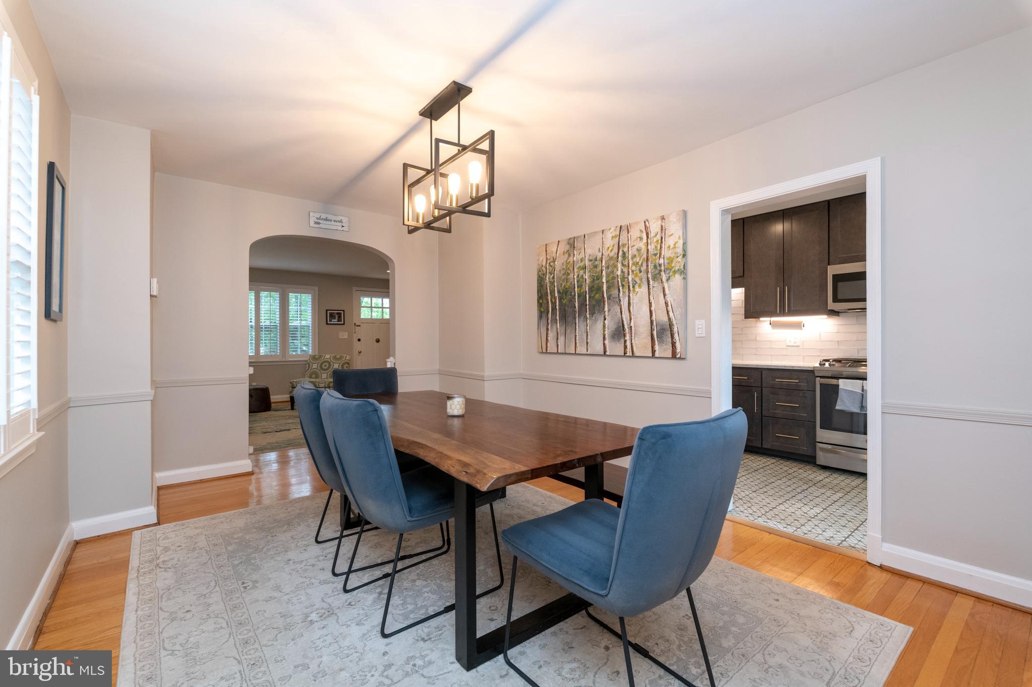 115 Brandon Road Baltimore, MD 21212 - Photo 8 of 39 a dining room with furniture a chandelier and wooden floor