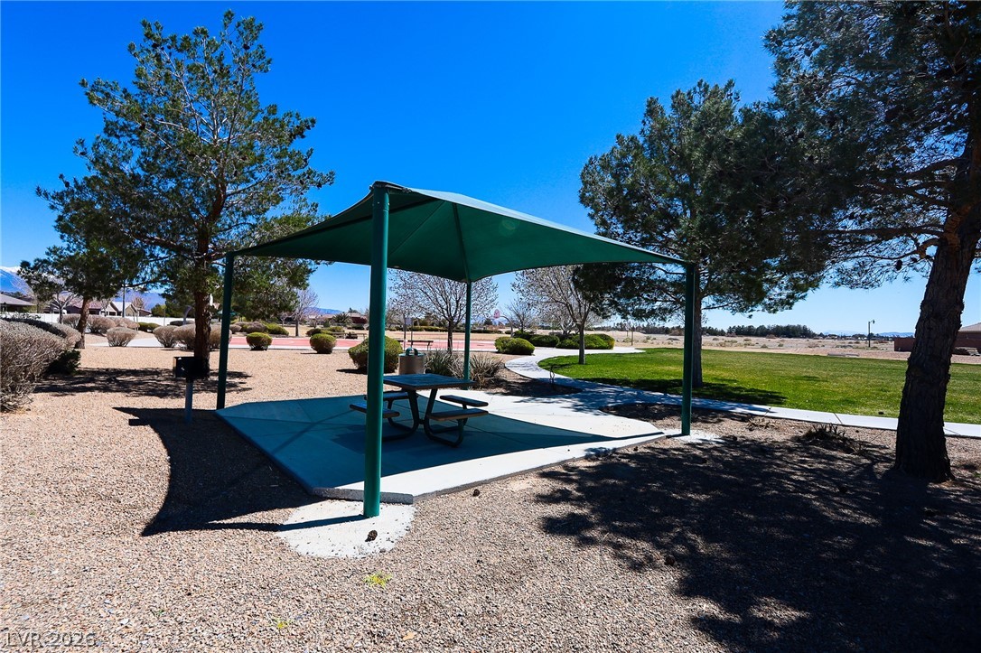 6472 Centennial Road Pahrump, NV 89048 - Photo 22 of 29 A community park with a shaded picnic area and surrounding greenery offers a serene outdoor retreat.