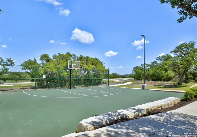 a view of a playground and basketball court