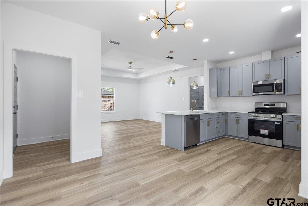 228 South Fenton Avenue Tyler, TX 75702 - Photo 11 of 46 a kitchen with stainless steel appliances kitchen island granite countertop a stove a sink and a refrigerator