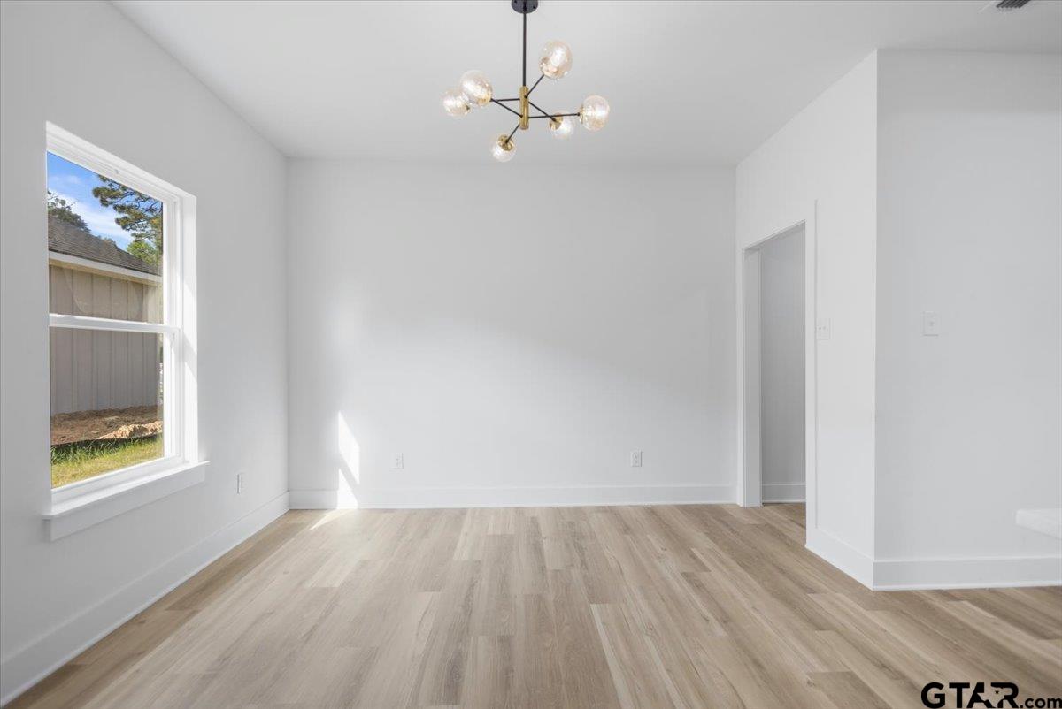228 South Fenton Avenue Tyler, TX 75702 - Photo 12 of 46 wooden floor in an empty room with a window