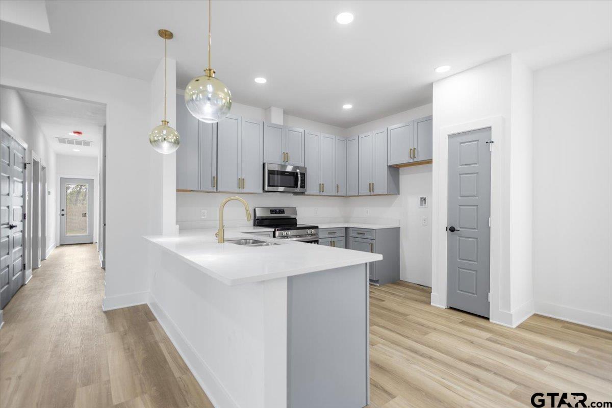 228 South Fenton Avenue Tyler, TX 75702 - Photo 14 of 46 a kitchen with kitchen island a sink stainless steel appliances and cabinets