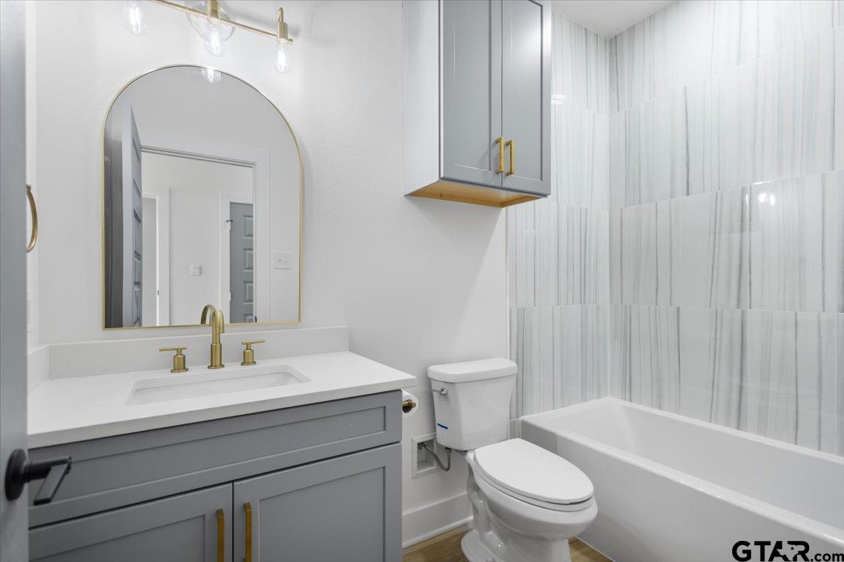 228 South Fenton Avenue Tyler, TX 75702 - Photo 17 of 46 a bathroom with a sink a toilet and shower
