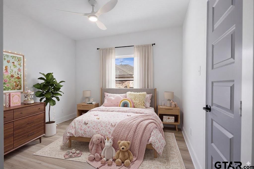228 South Fenton Avenue Tyler, TX 75702 - Photo 19 of 46 a bedroom with a bed and a potted plant