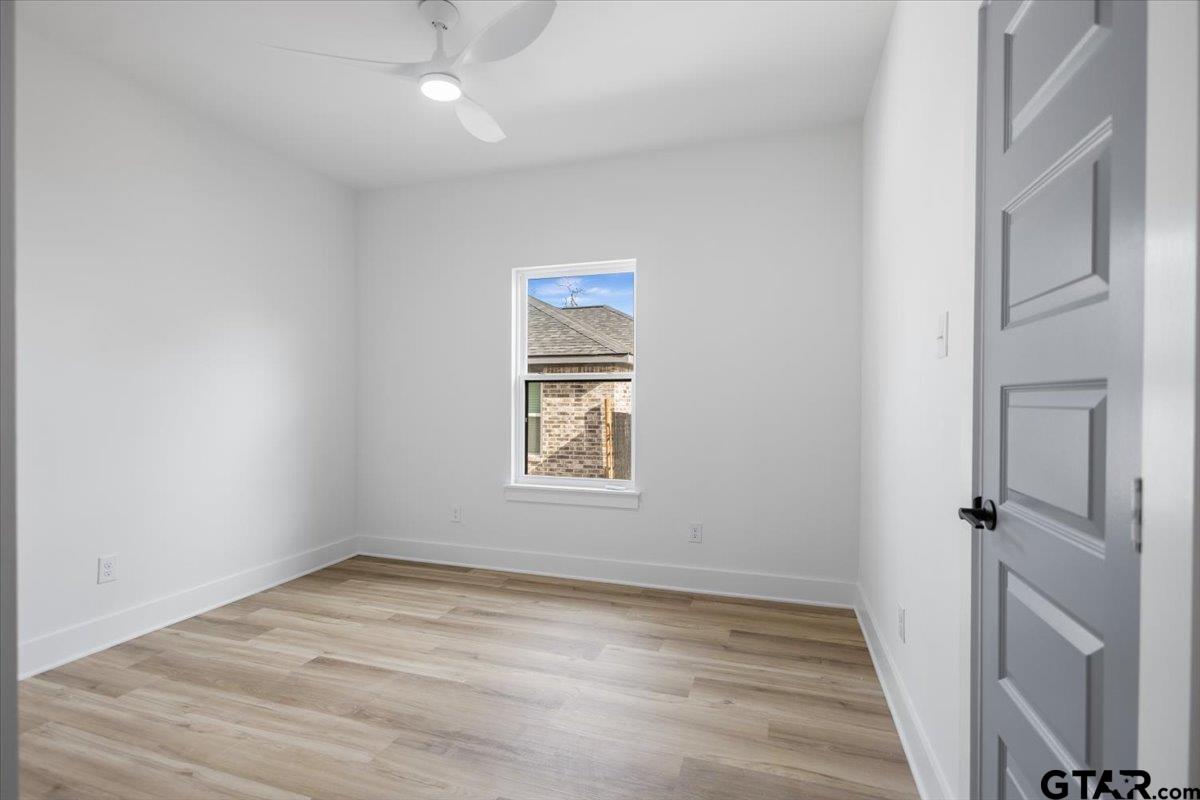 228 South Fenton Avenue Tyler, TX 75702 - Photo 20 of 46 wooden floor in an empty room with a window