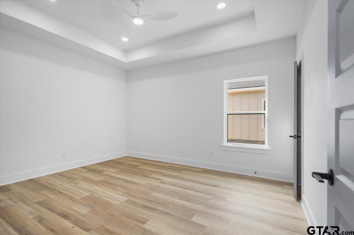 228 South Fenton Avenue Tyler, TX 75702 - Photo 25 of 46 an empty room with wooden floor and windows
