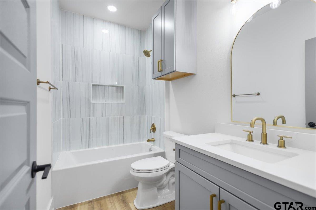 228 South Fenton Avenue Tyler, TX 75702 - Photo 29 of 46 a bathroom with a sink a toilet and shower