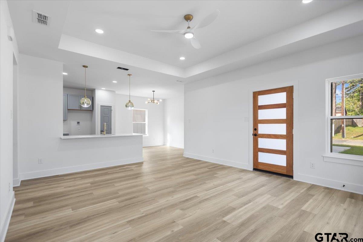 228 South Fenton Avenue Tyler, TX 75702 - Photo 6 of 46 a view of an empty room with a window and wooden floor