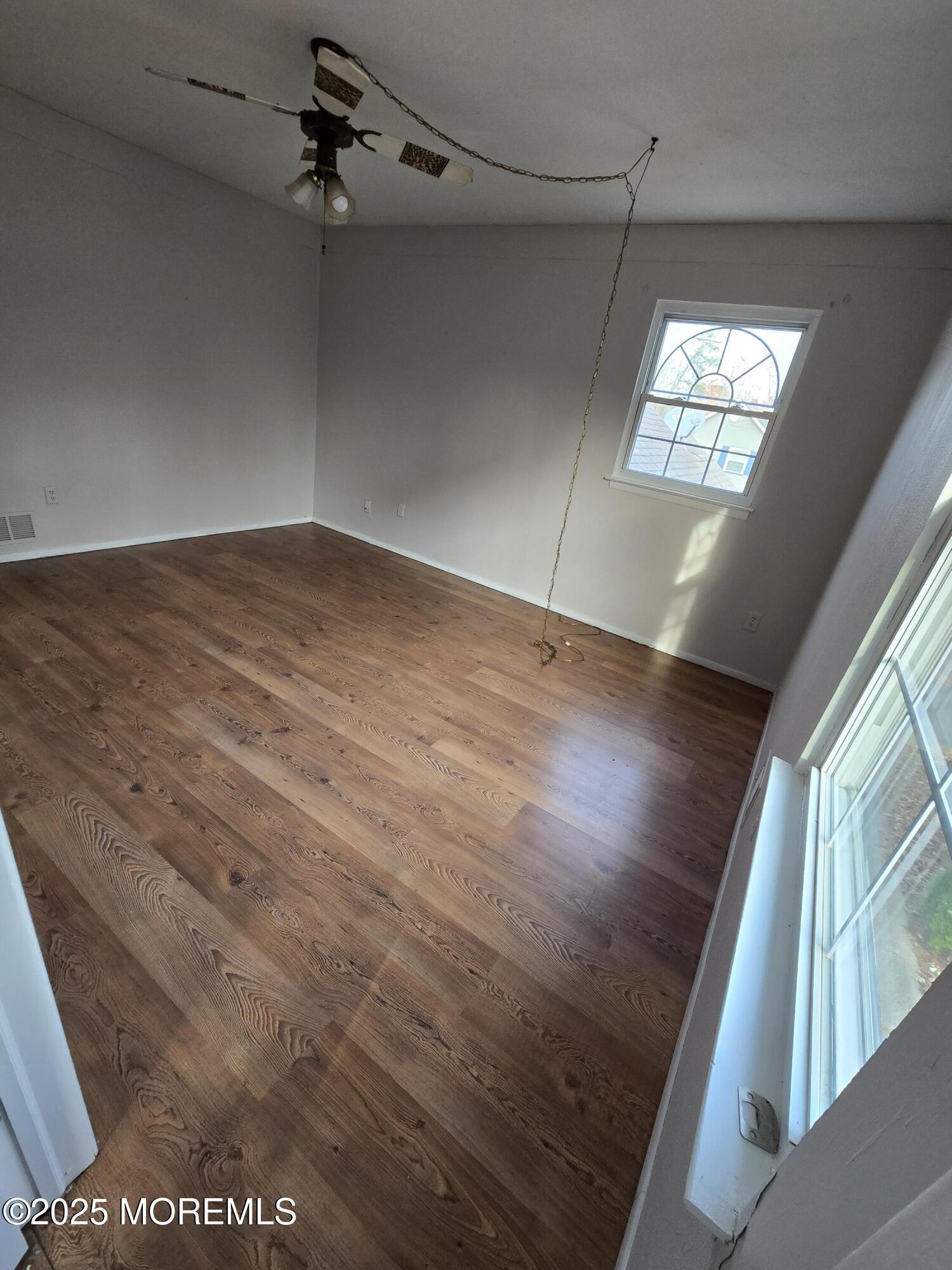 802 Miller Avenue Jackson, NJ 08527 - Photo 11 of 20 wooden floor in an empty room with a window
