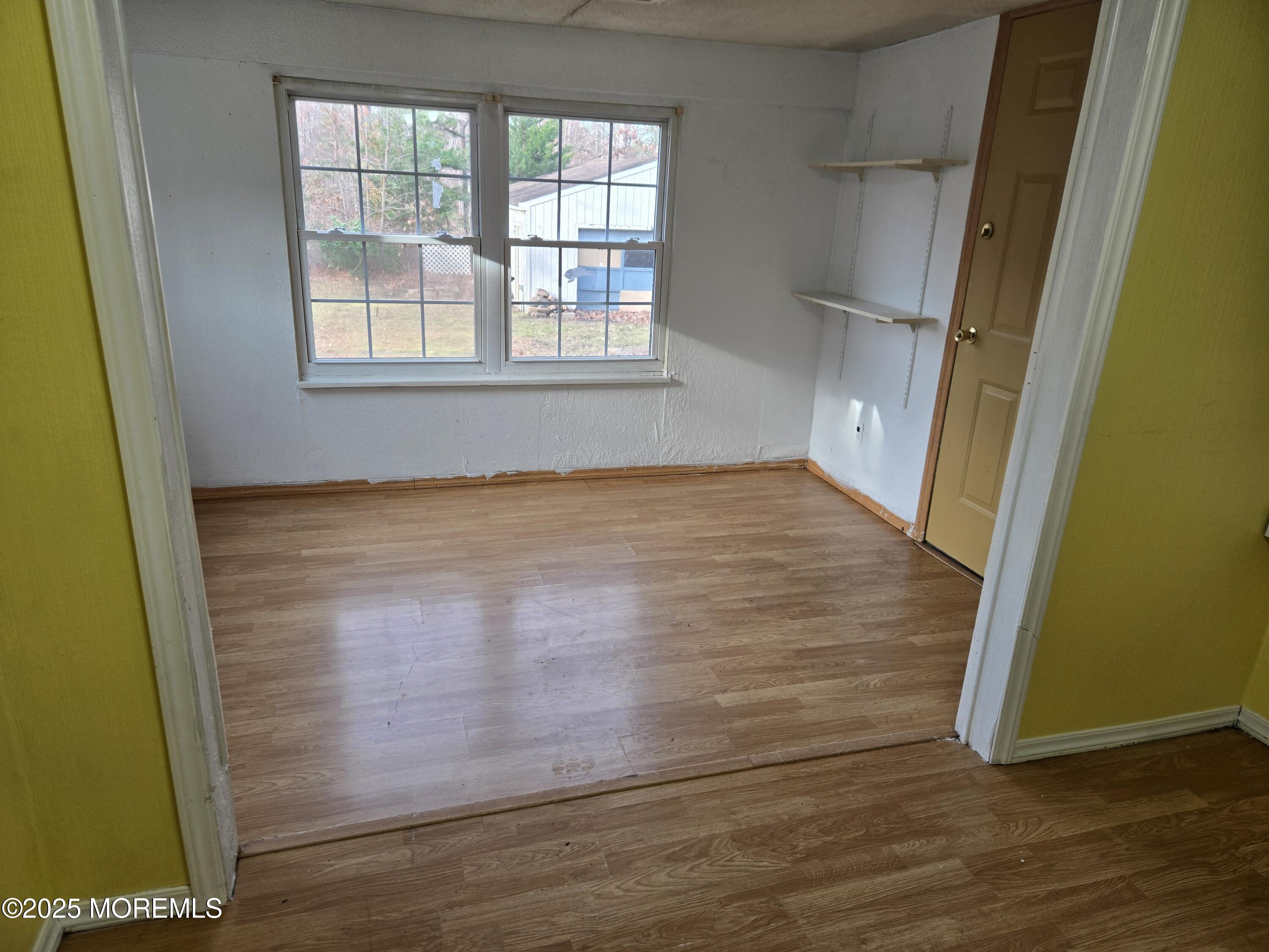 802 Miller Avenue Jackson, NJ 08527 - Photo 7 of 20 an empty room with wooden floor and windows