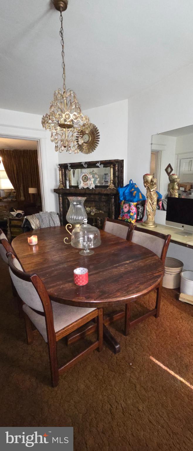 1116 Allison Street Northwest Washington, DC 20011 - Photo 27 of 41 a living room with furniture a chandelier and a flat screen tv
