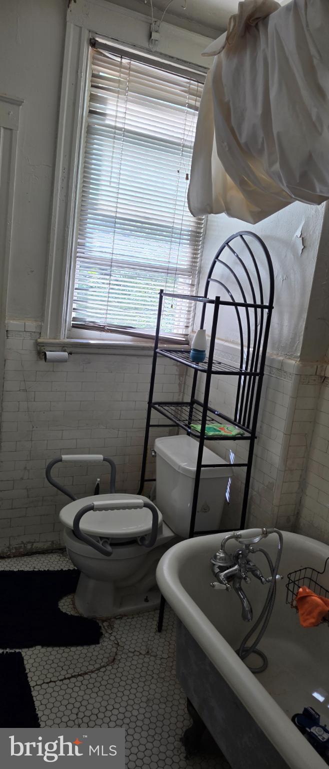 1116 Allison Street Northwest Washington, DC 20011 - Photo 8 of 41 a bathroom with a toilet a sink and a window
