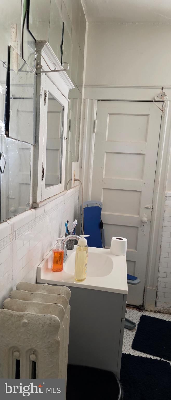 1116 Allison Street Northwest Washington, DC 20011 - Photo 10 of 41 a bathroom with a sink and a mirror