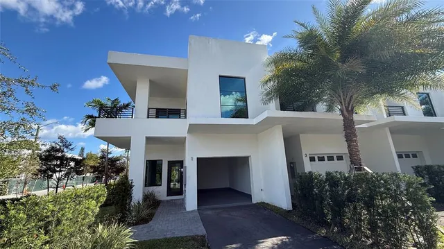 a front view of a house with a yard and a garage