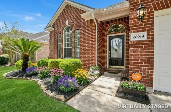 a front view of a house with a yard and outdoor seating