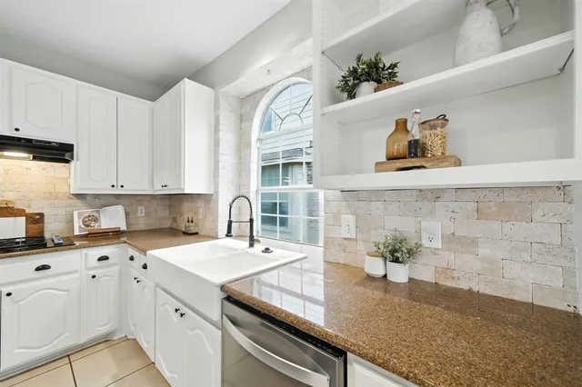 a kitchen with a sink dishwasher and cabinets