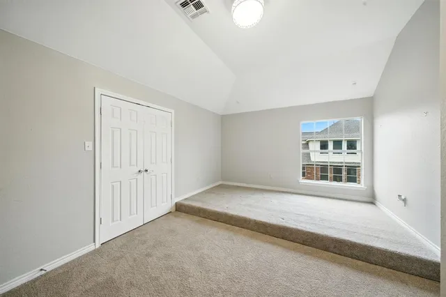 an empty room with ceiling fan and entryway