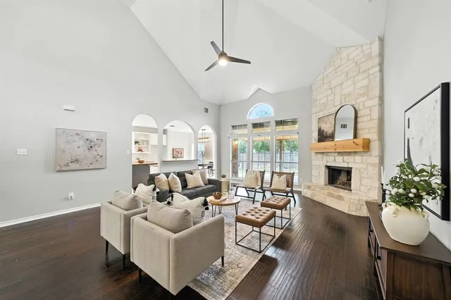 a living room with furniture a fireplace and a floor to ceiling window