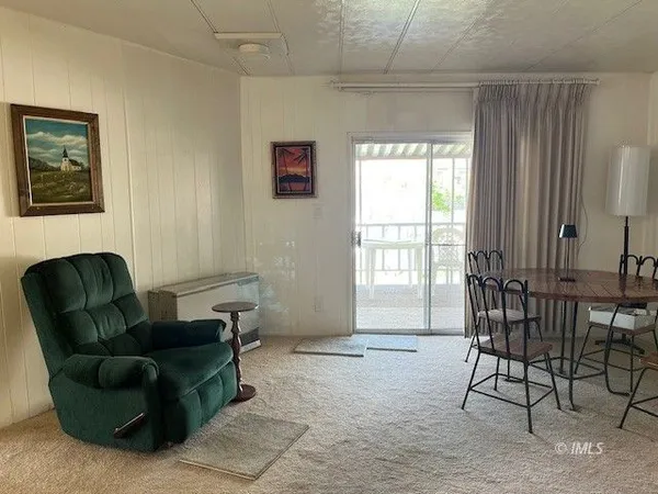 a dining room with furniture and wooden floor
