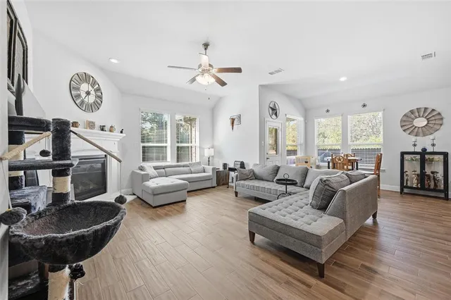 a living room with furniture and kitchen view