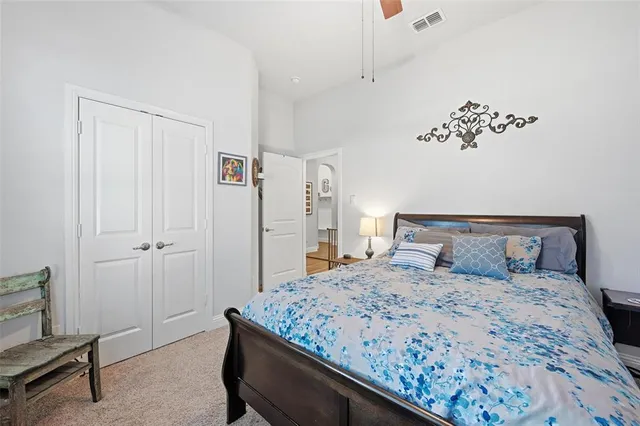 a bedroom with a bed and a painting on the wall