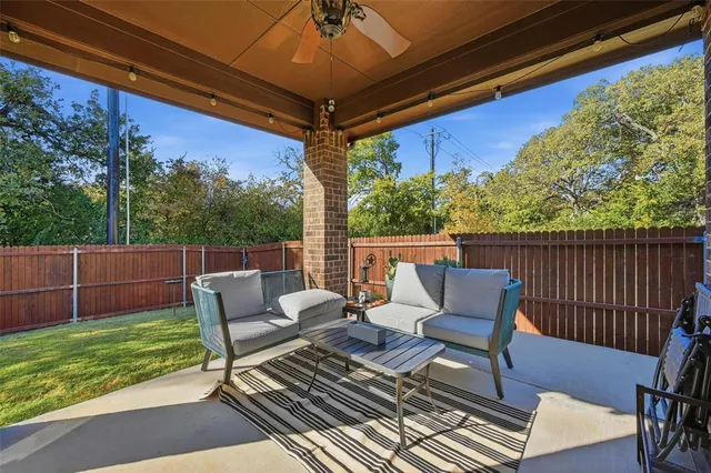 a view of house with a big yard and potted plants