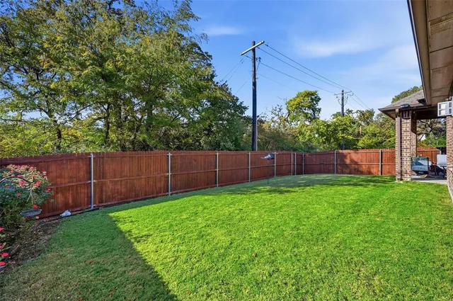a view of pool and trees in the background