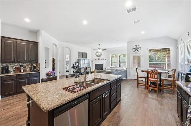a large kitchen with lots of counter top space and stainless steel appliances