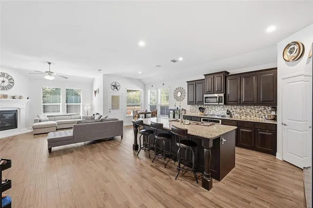 a kitchen with granite countertop stainless steel appliances and wooden cabinets
