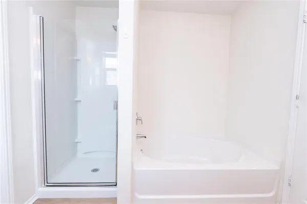 a bathroom with bathtub and shower