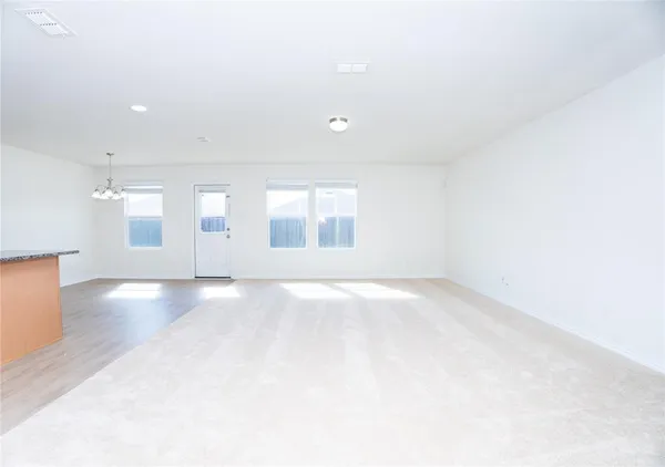 an empty room with windows and pillars in it