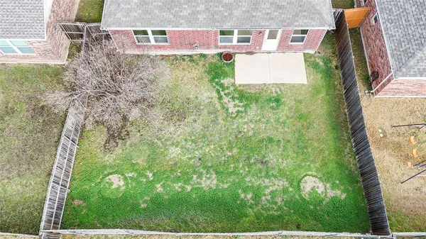 an aerial view of a house with yard