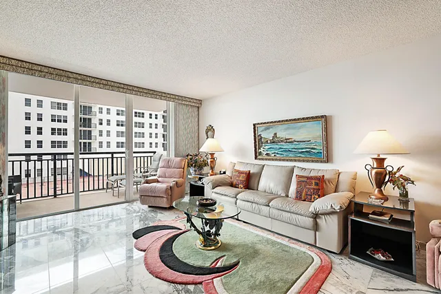 a living room with furniture and a floor to ceiling window